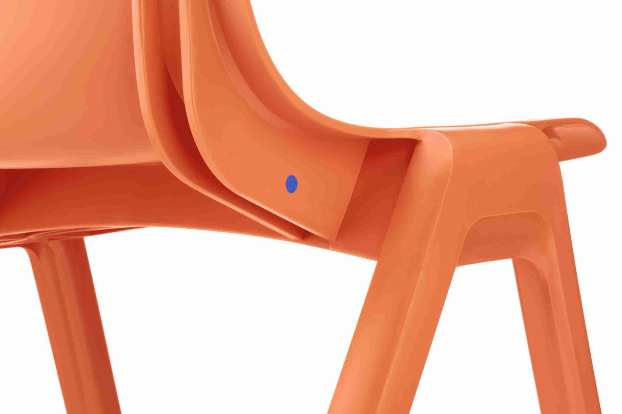 Close-up of orange Ergostak Chair showcasing ergonomic design and sleek aesthetics.