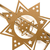 Decorative star pattern on a durable gold steel Christmas tree stand.