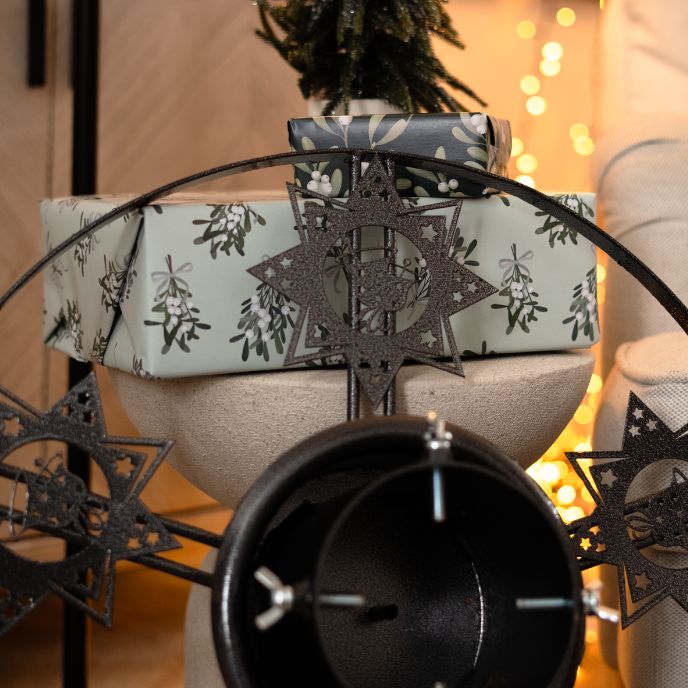 Decorative star Christmas tree stand in grey durable steel with integrated water reservoir.