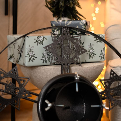 Decorative star Christmas tree stand in grey durable steel with integrated water reservoir.